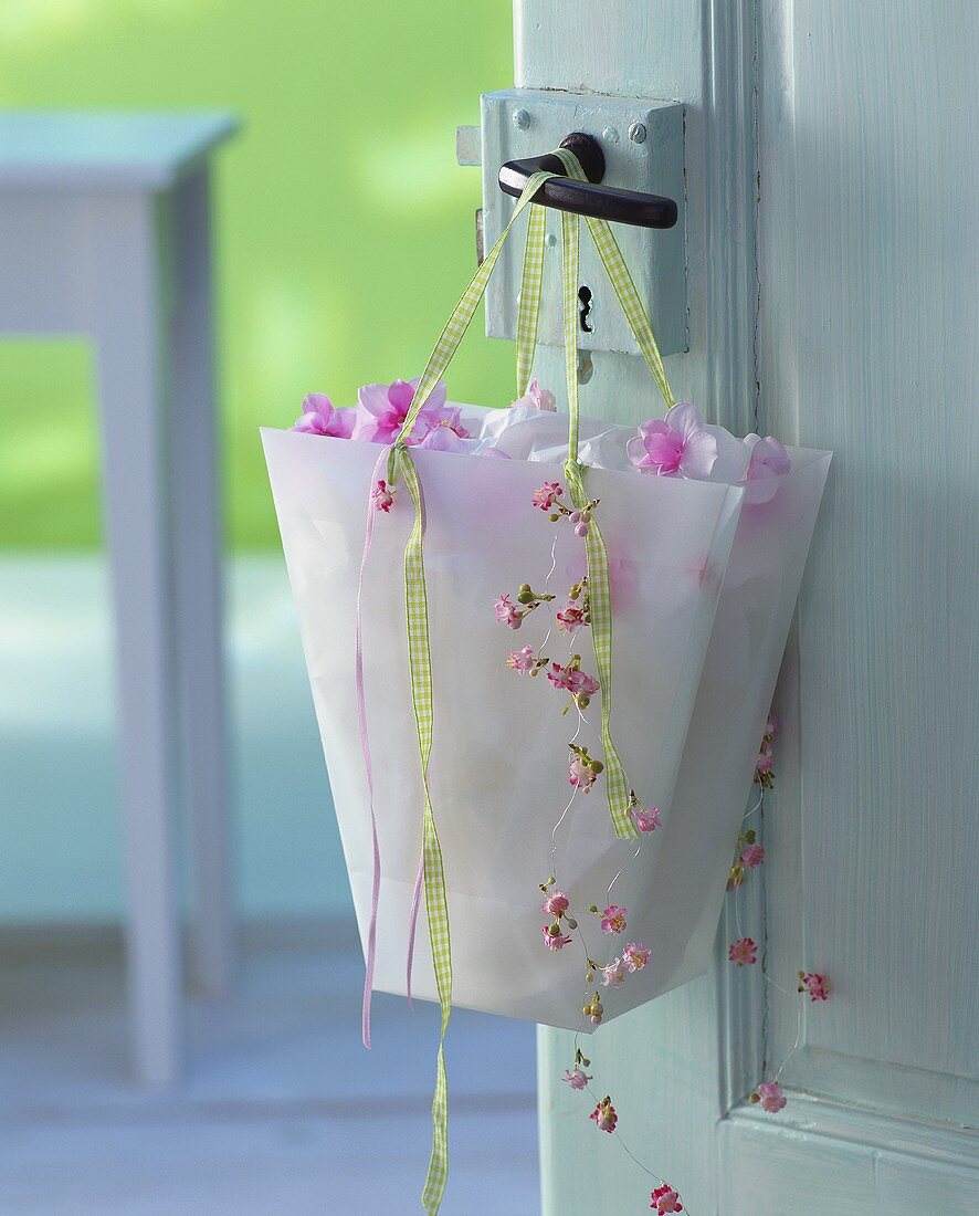 Bag with checked ribbon and artificial cherry blossom