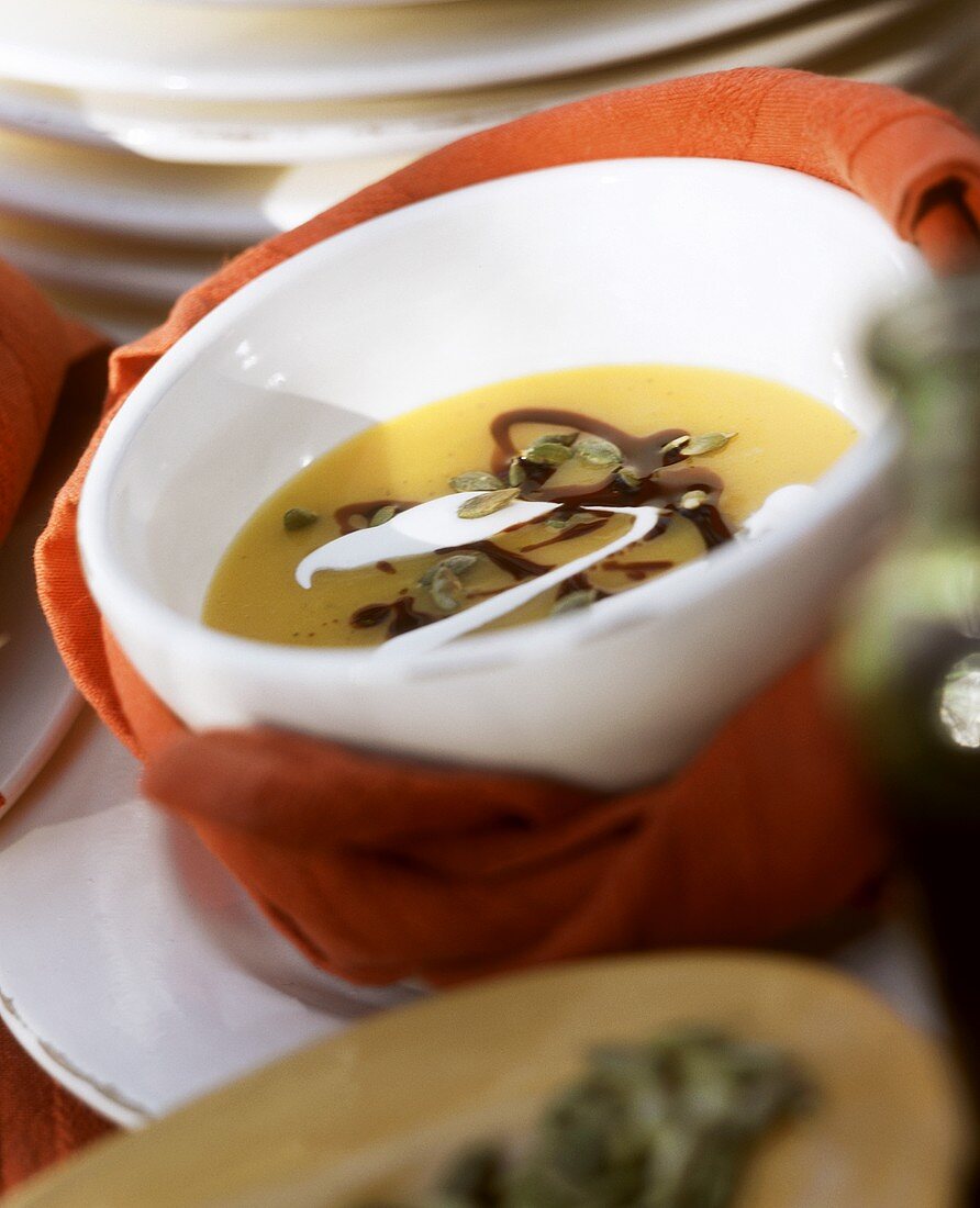 Pumpkin soup with pumpkin seeds, pumpkin seed oil & cream
