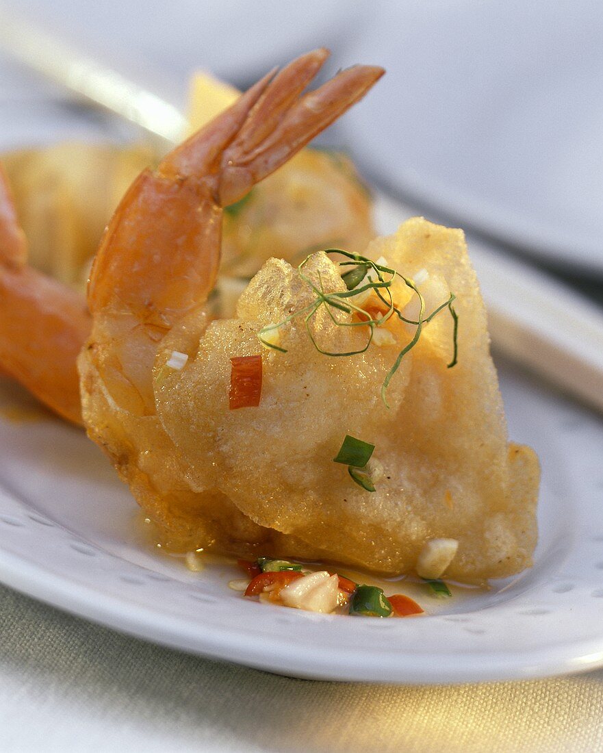 Scampi in rice paper with small pieces of vegetable