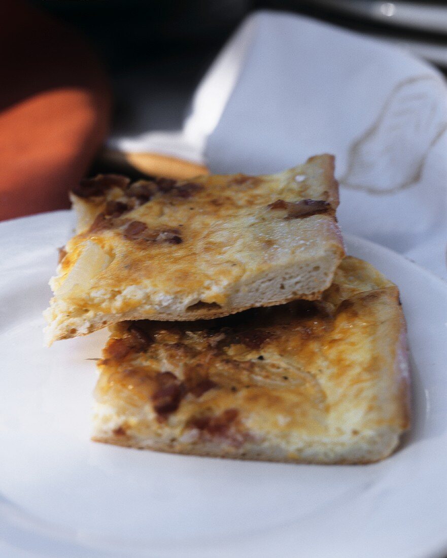 Two pieces of quiche Lorraine with eggs and bacon