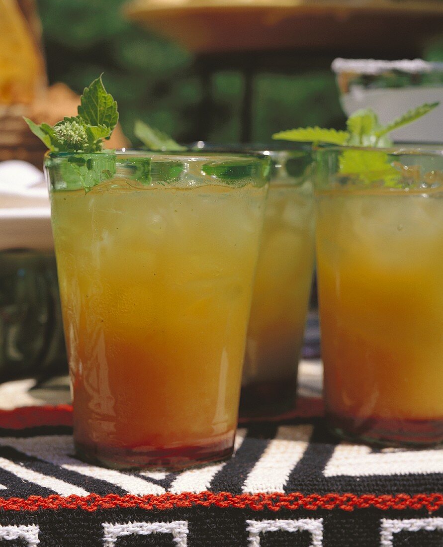 Mexican drinks with orange juice and ice cubes