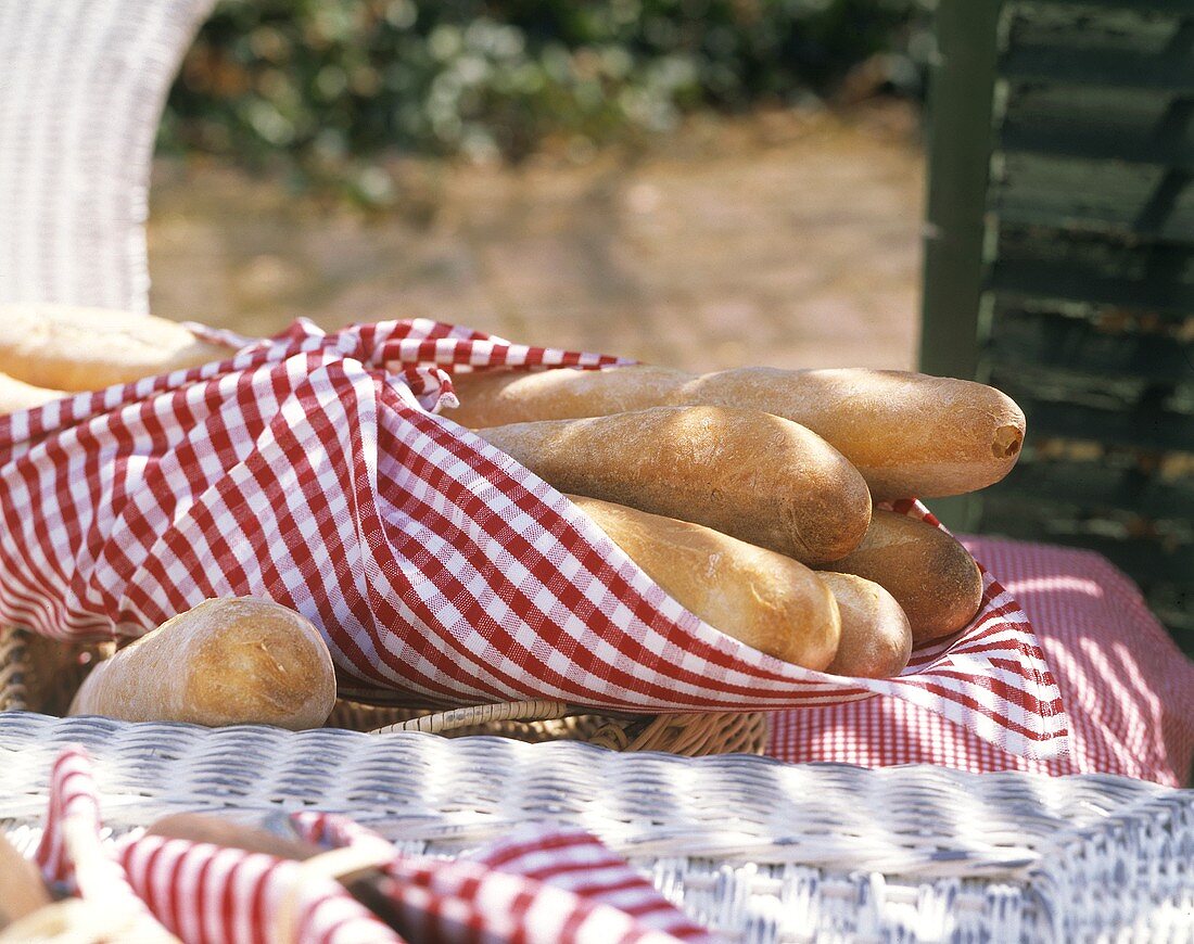 Several Baguettes in a Checkered Towel; Outdoors
