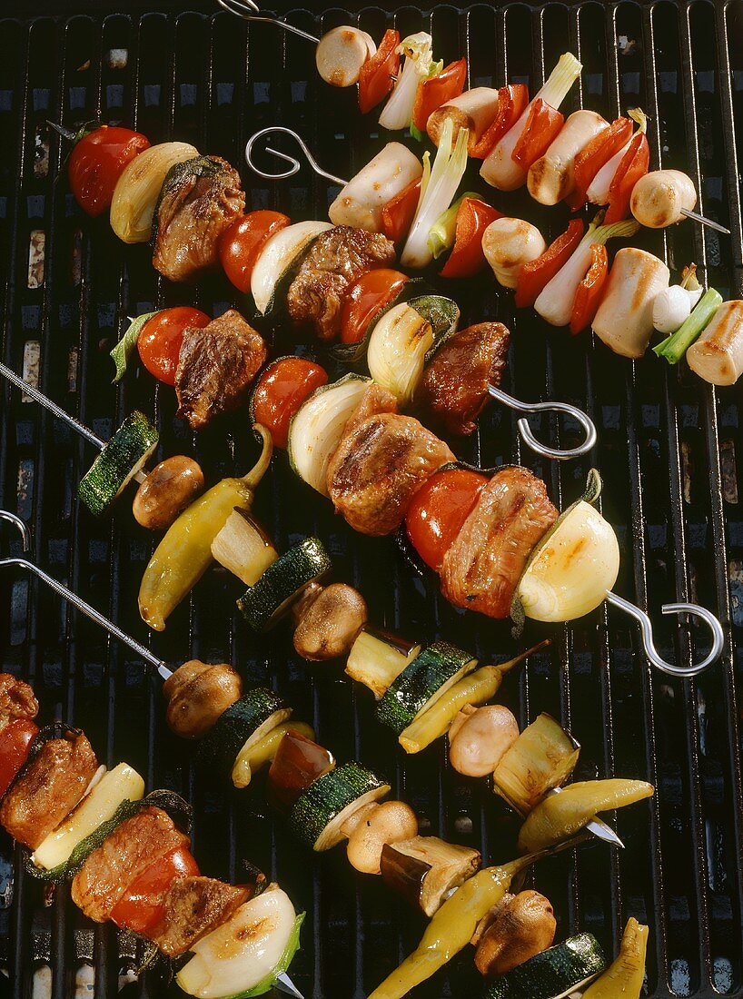 Grilled kebabs with vegetables, lamb & sausages