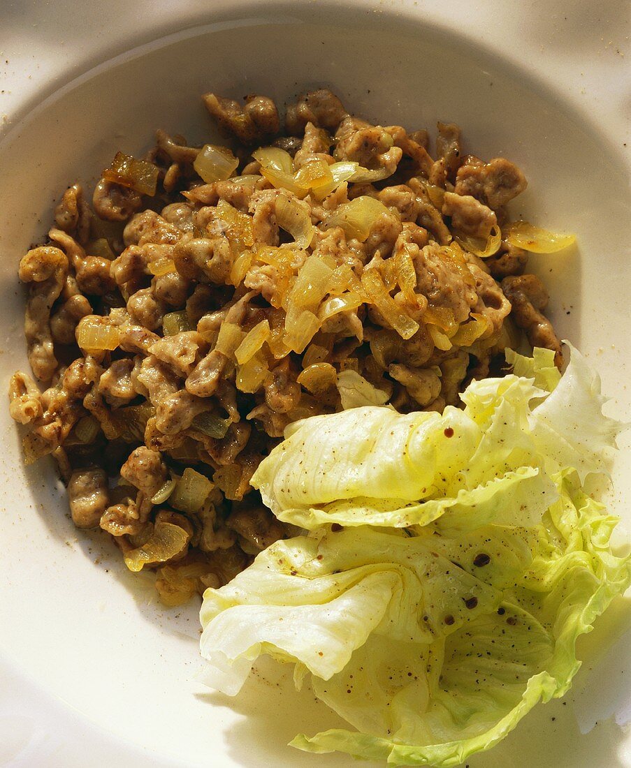 Liver noodles (spaetzle) with diced onion, with lettuce garnish