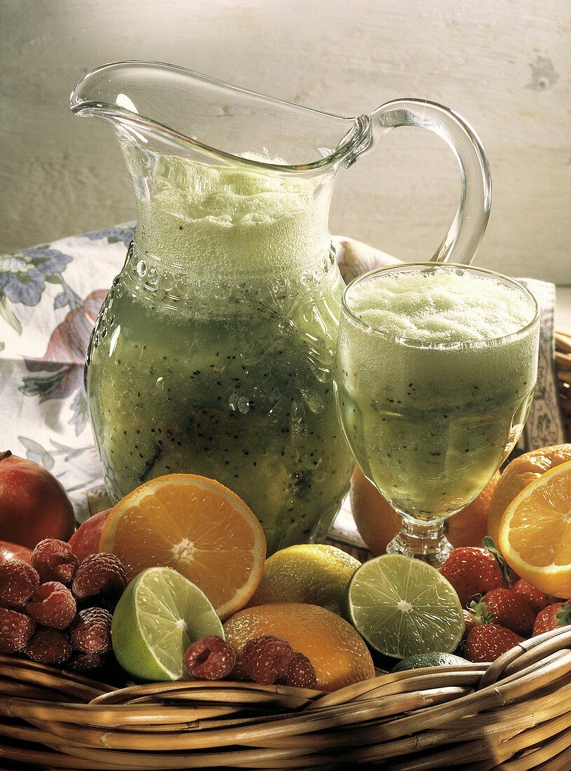 Kiwi Smoothie in a Pitcher and Glass; Fresh Fruit