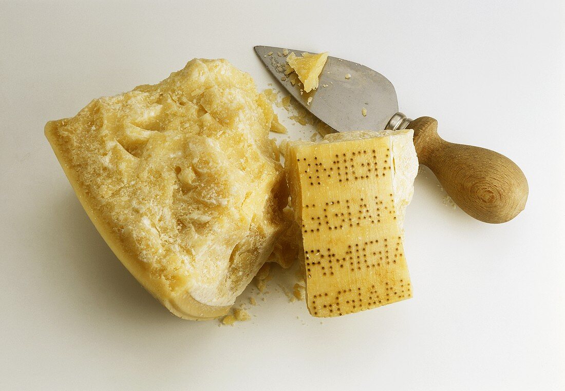 A piece of Parmigiano Reggiano with Parmesan knife
