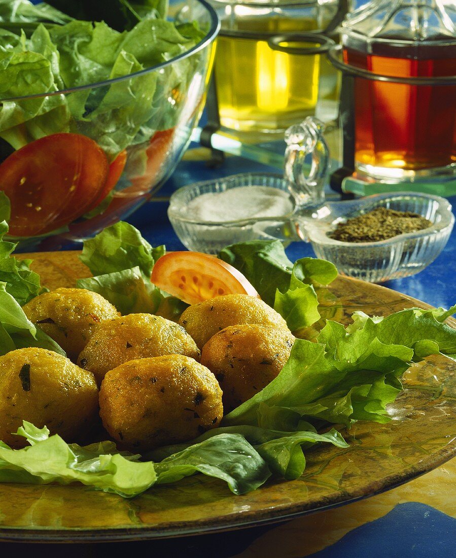 Deep-fried stockfish balls on salad leaves