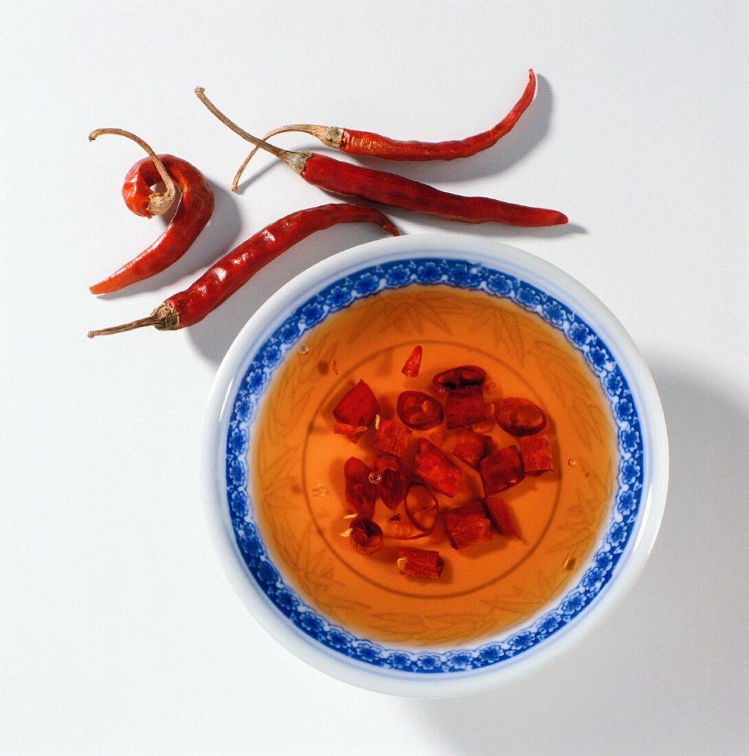 Bowl of chili sauce and dried chili peppers