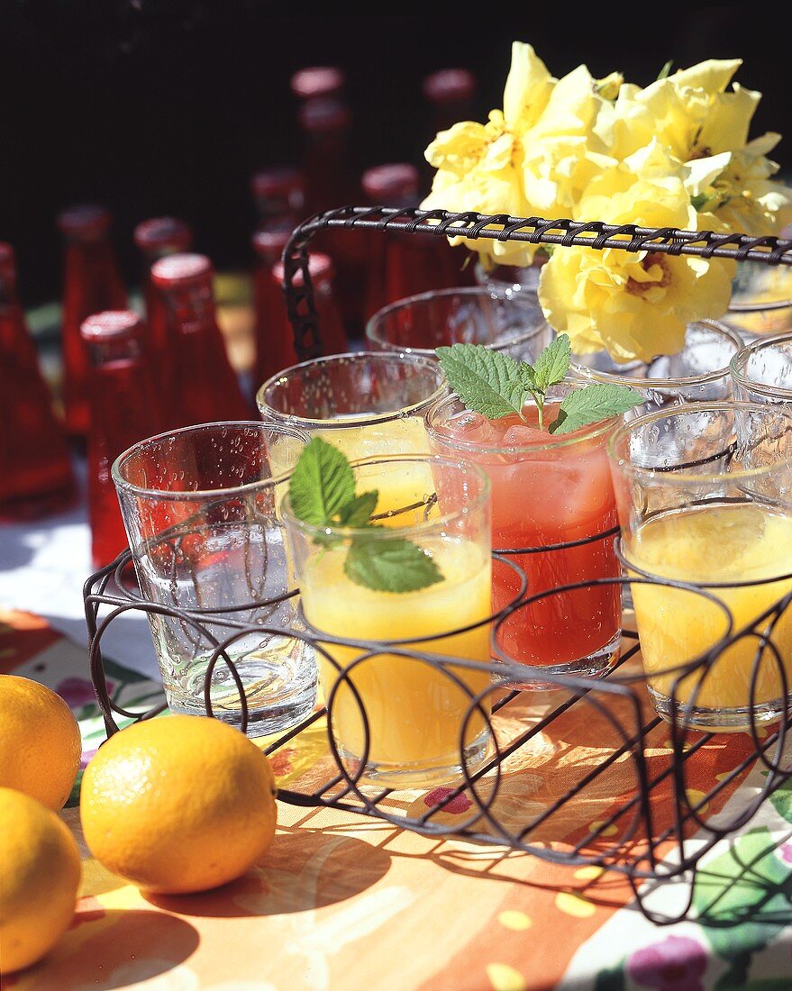 Refreshing drinks with orange juice & Campari in wire basket