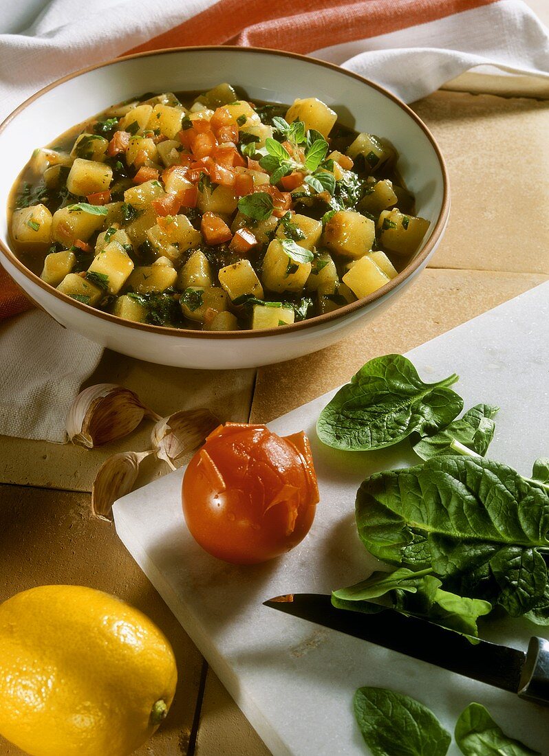 Potatoes cooked in stock with spinach, tomatoes & oregano