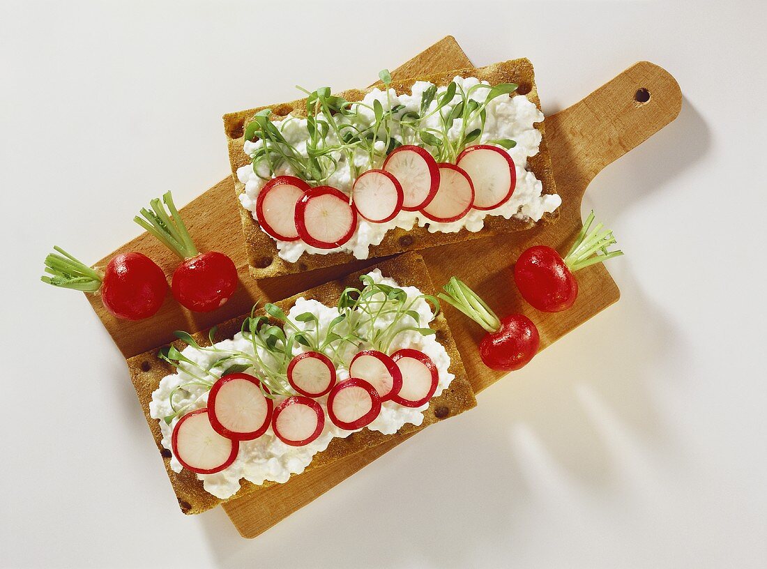 Two crispbreads with soft cheese, radishes & cress