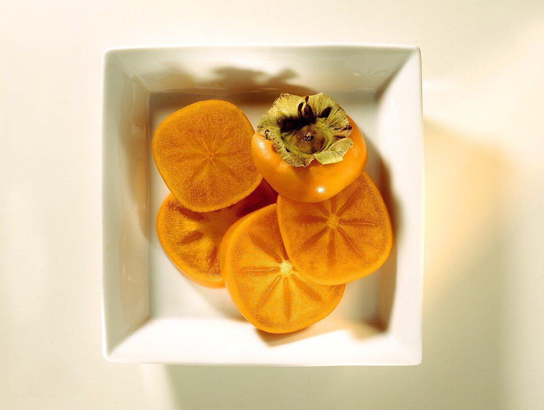 Sliced Persimmons in a White Dish