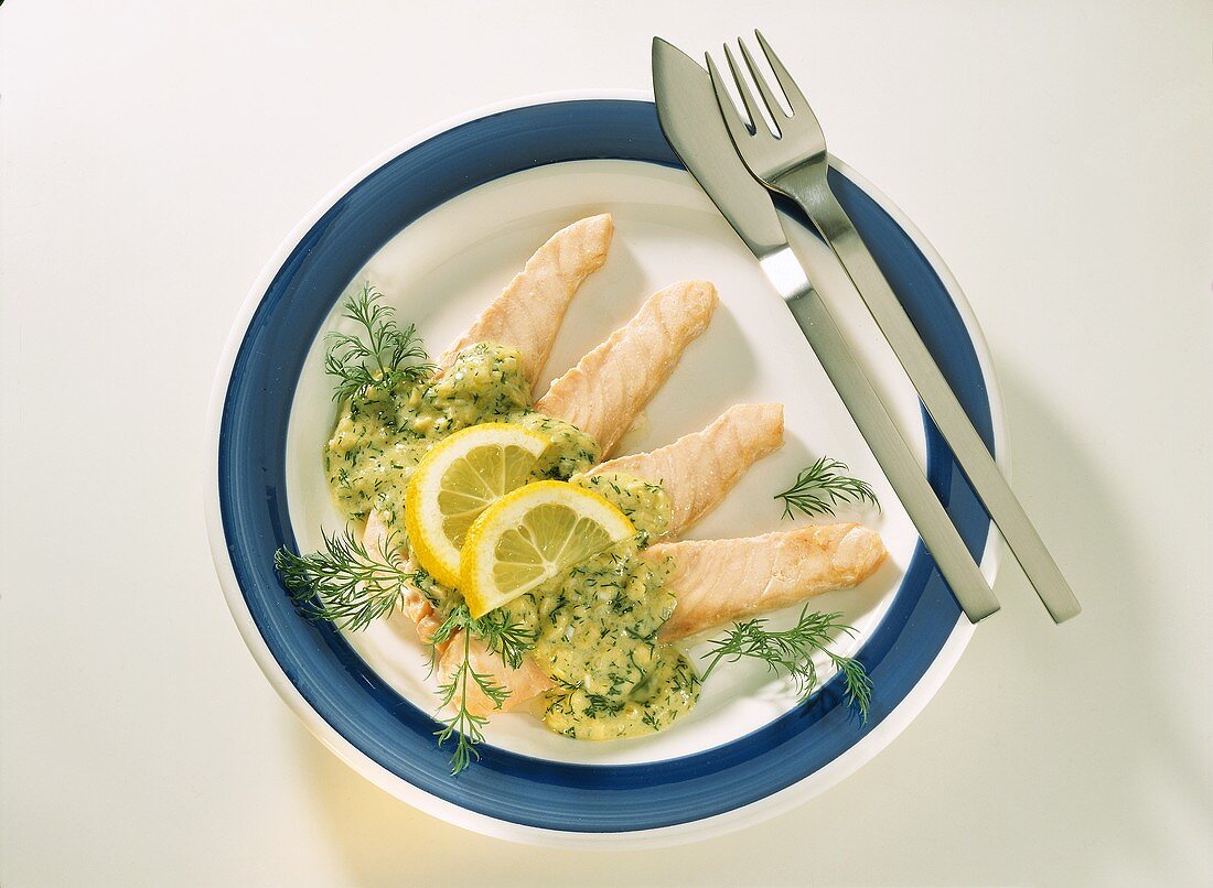 Strips of salmon with dill & ginger sauce and lemon slices