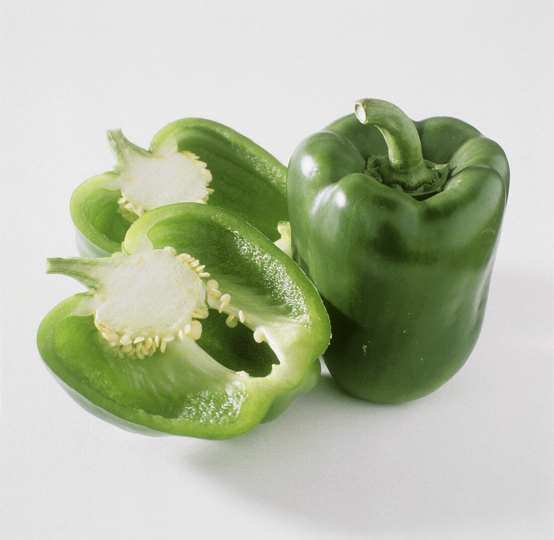 A whole green pepper and two halves