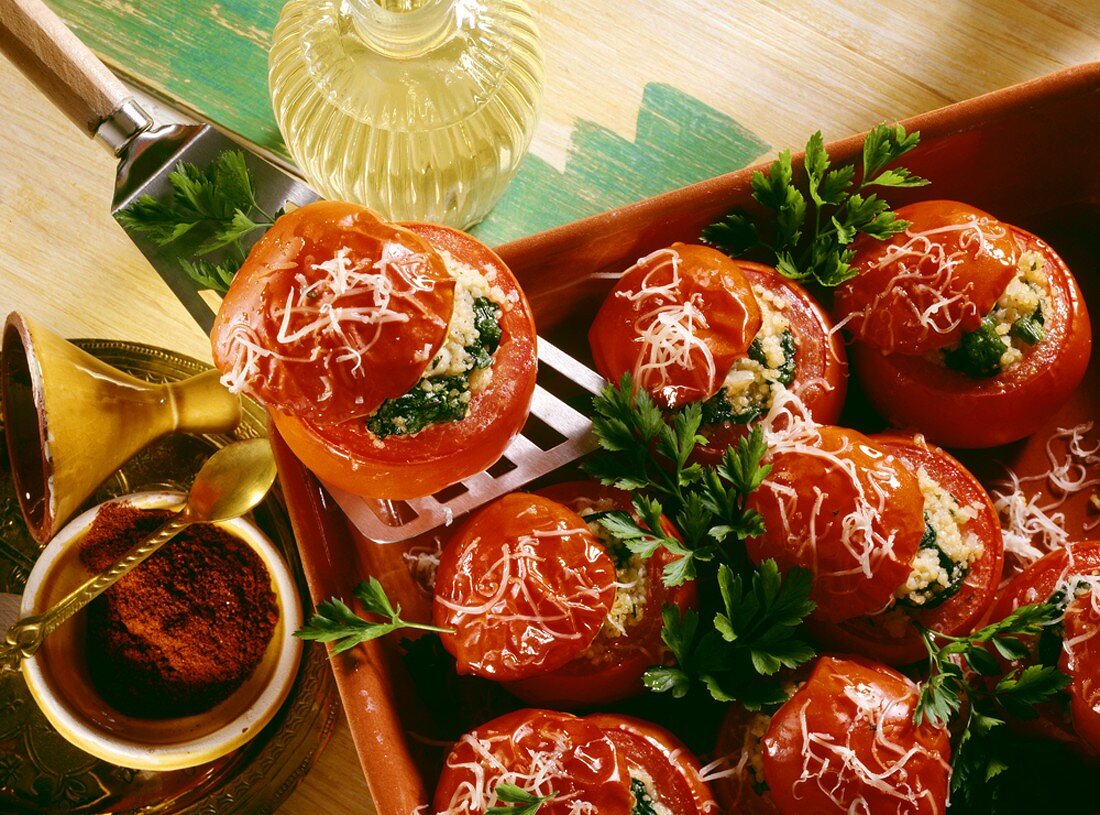 Tomatoes stuffed with couscous with spinach & grated cheese