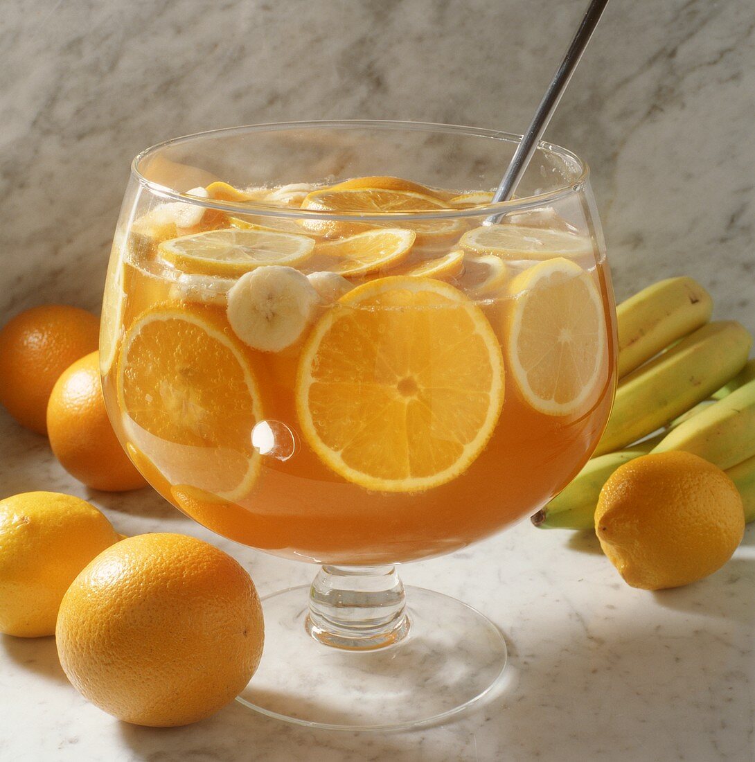 Orange punch with orange slices, lemons & bananas