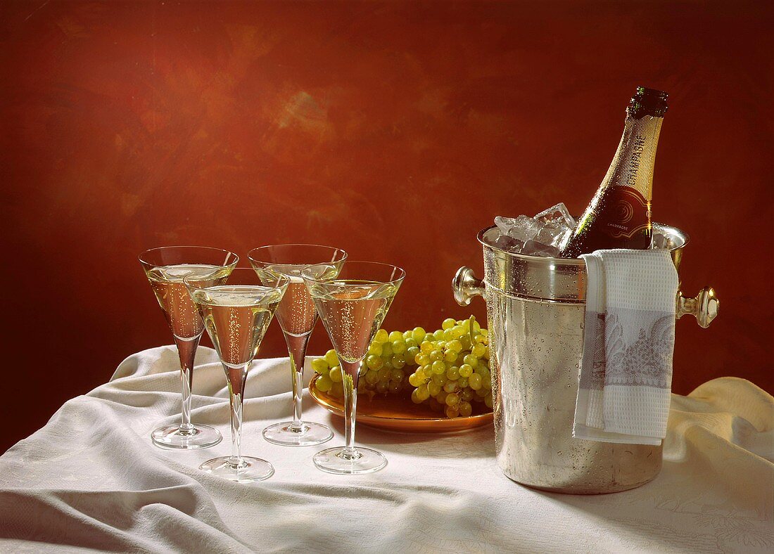 Four Glasses of Champagne; Champagne Bottle in Ice Bucket