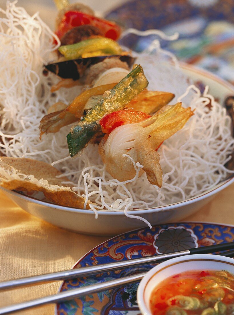 Fried vegetable kebab on Asian noodles and vinegar dip