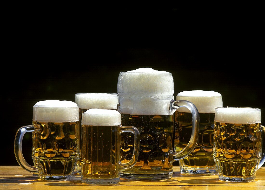 Various full beer tankards on beer table