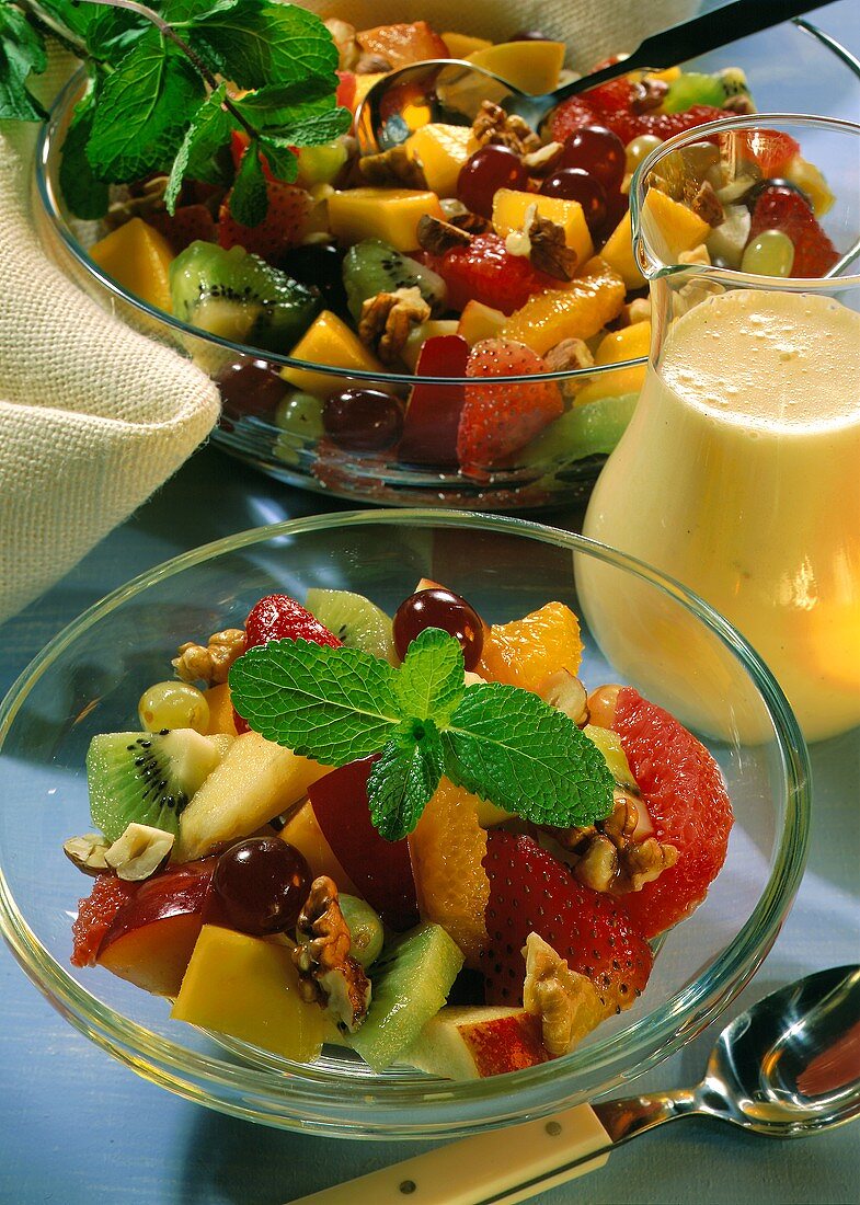 Mixed fruit salad with nuts and mint leaf