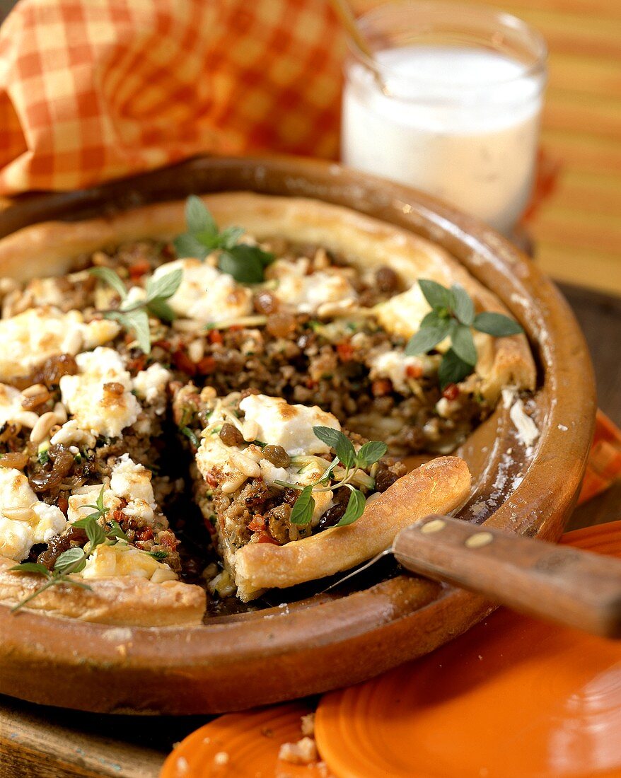 Lamb quiche with raisins & pine nuts, sheep's cheese & oregano