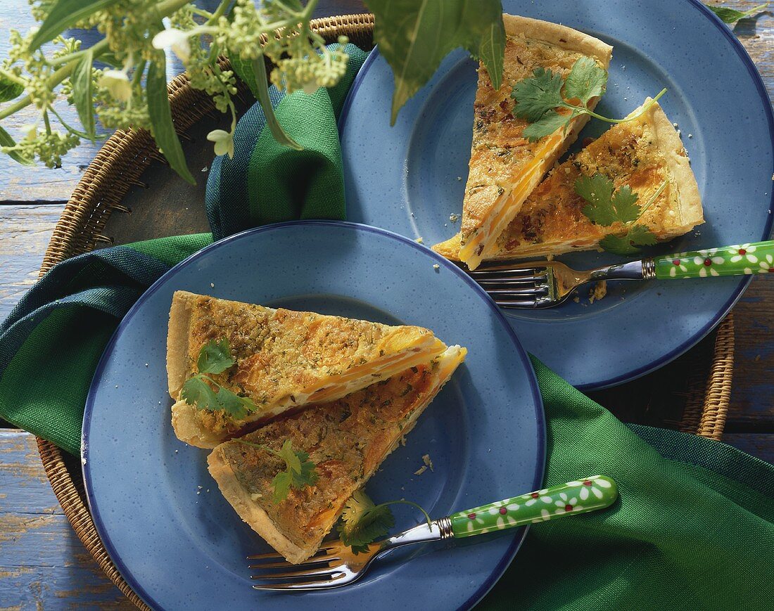 Carrot & bacon quiche with coriander, two pieces on plates