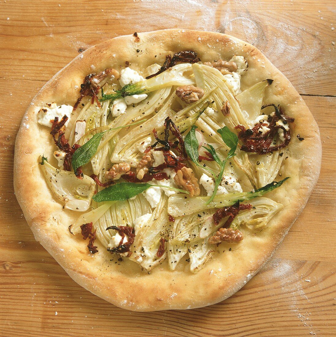 Fennel pizza with walnuts, goat's cheese, dried tomatoes