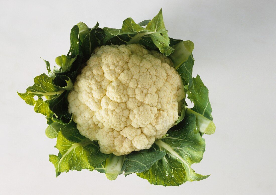 A cauliflower with green leaves
