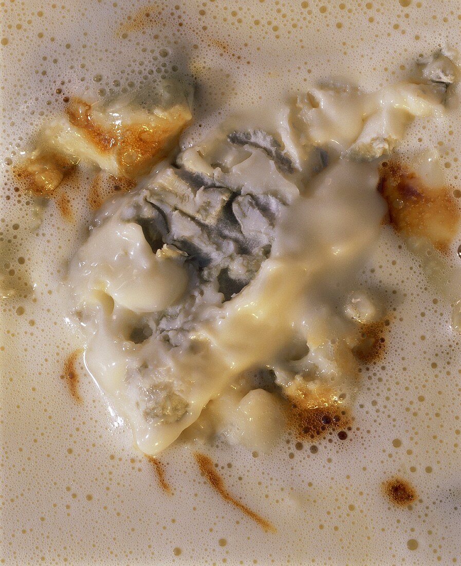 Cream sauce with a large piece of gorgonzola (close-up)