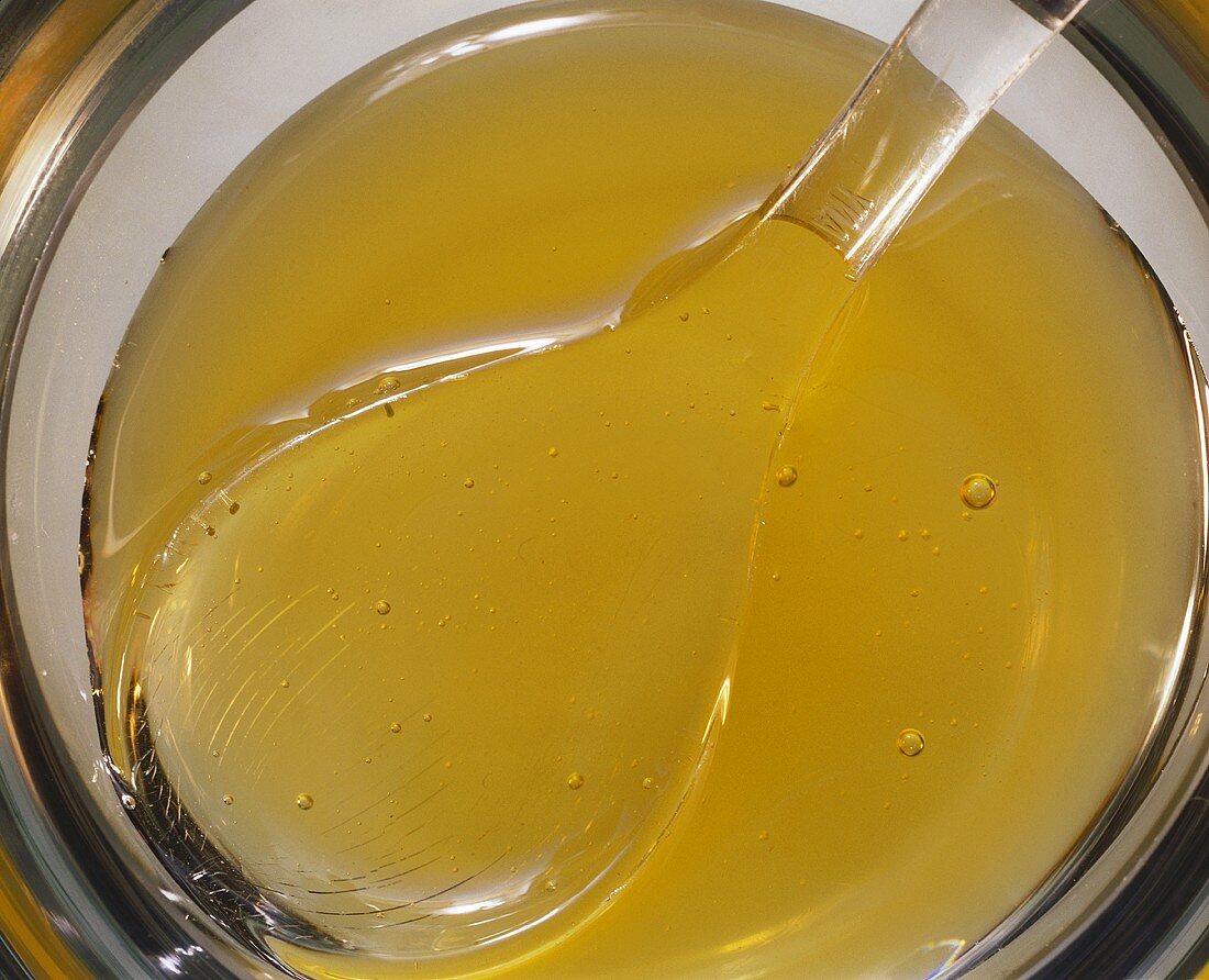 Acacia honey in bowl with spoon