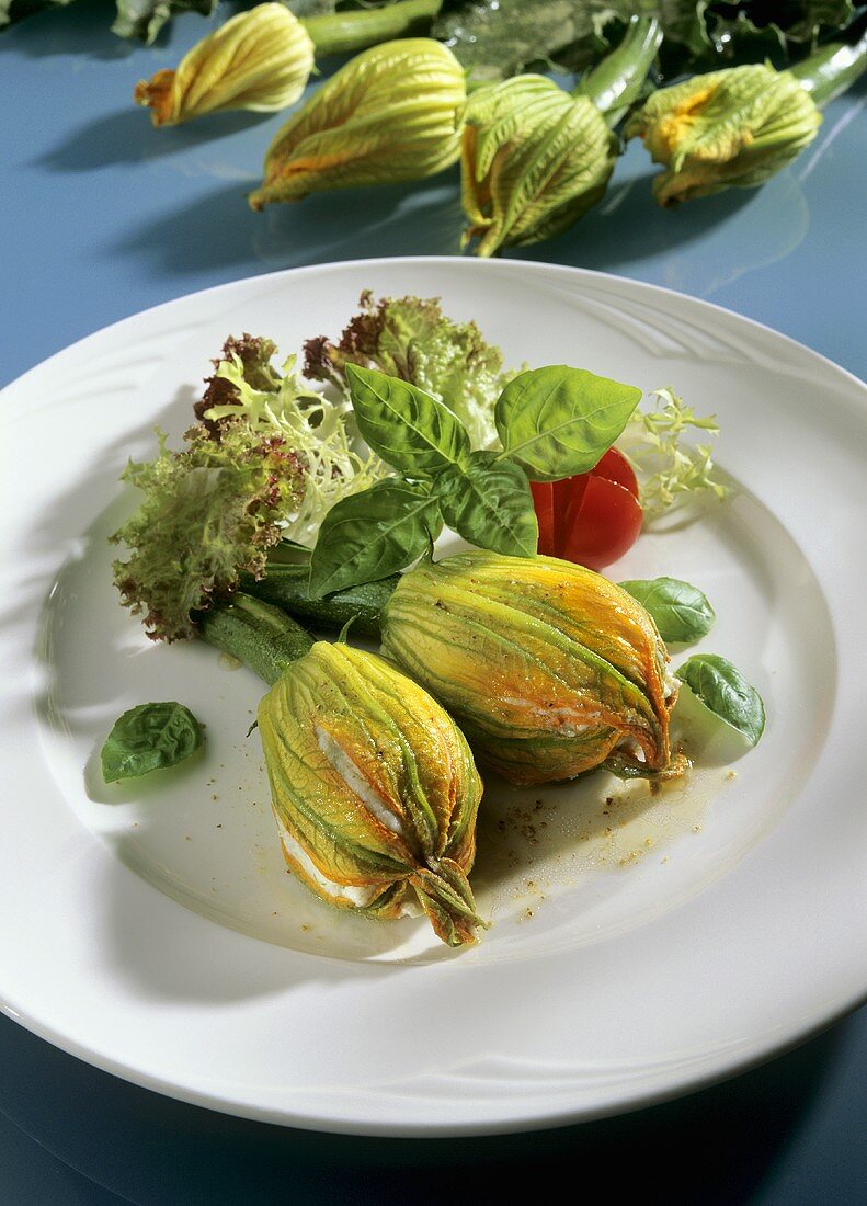 Stuffed courgette flowers with basil and salad garnish