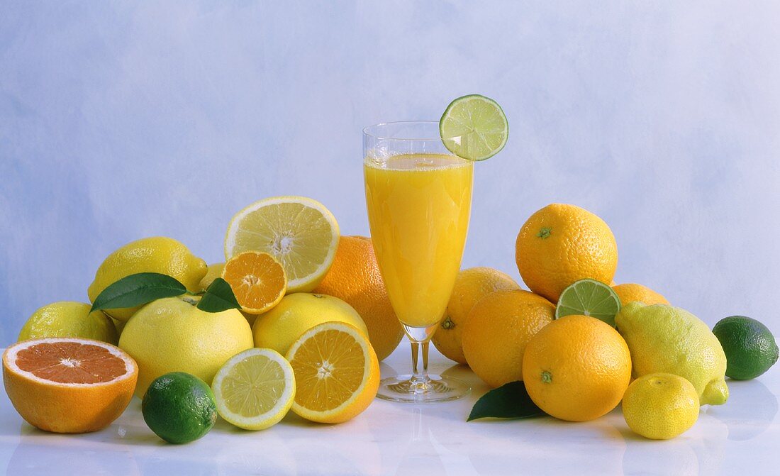 Citrus fruits and a glass of citrus fruit juice