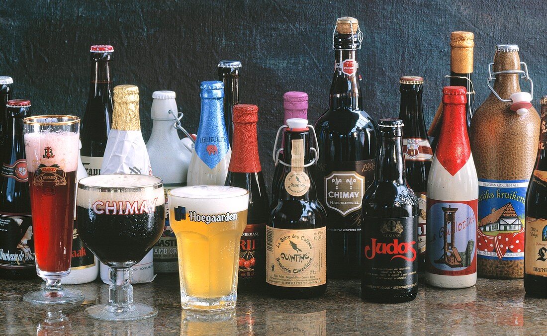 Various types of Belgian beer in bottles & glasses