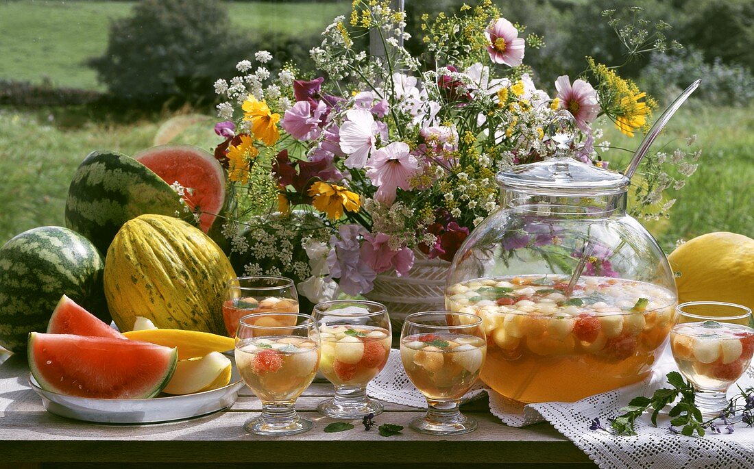 Melon punch, melons & flowers on summer garden buffet