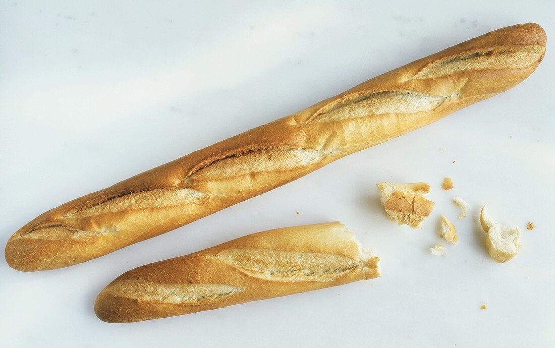 Whole & half baguette and a few broken pieces of bread