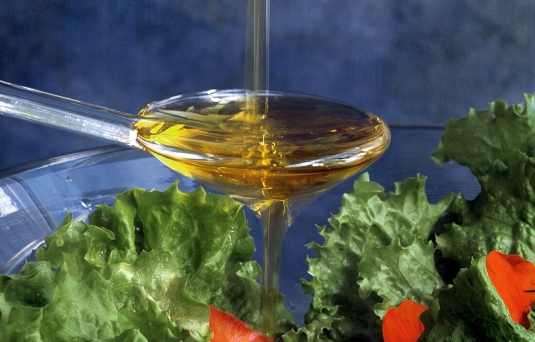 Pouring Oil Over a Salad