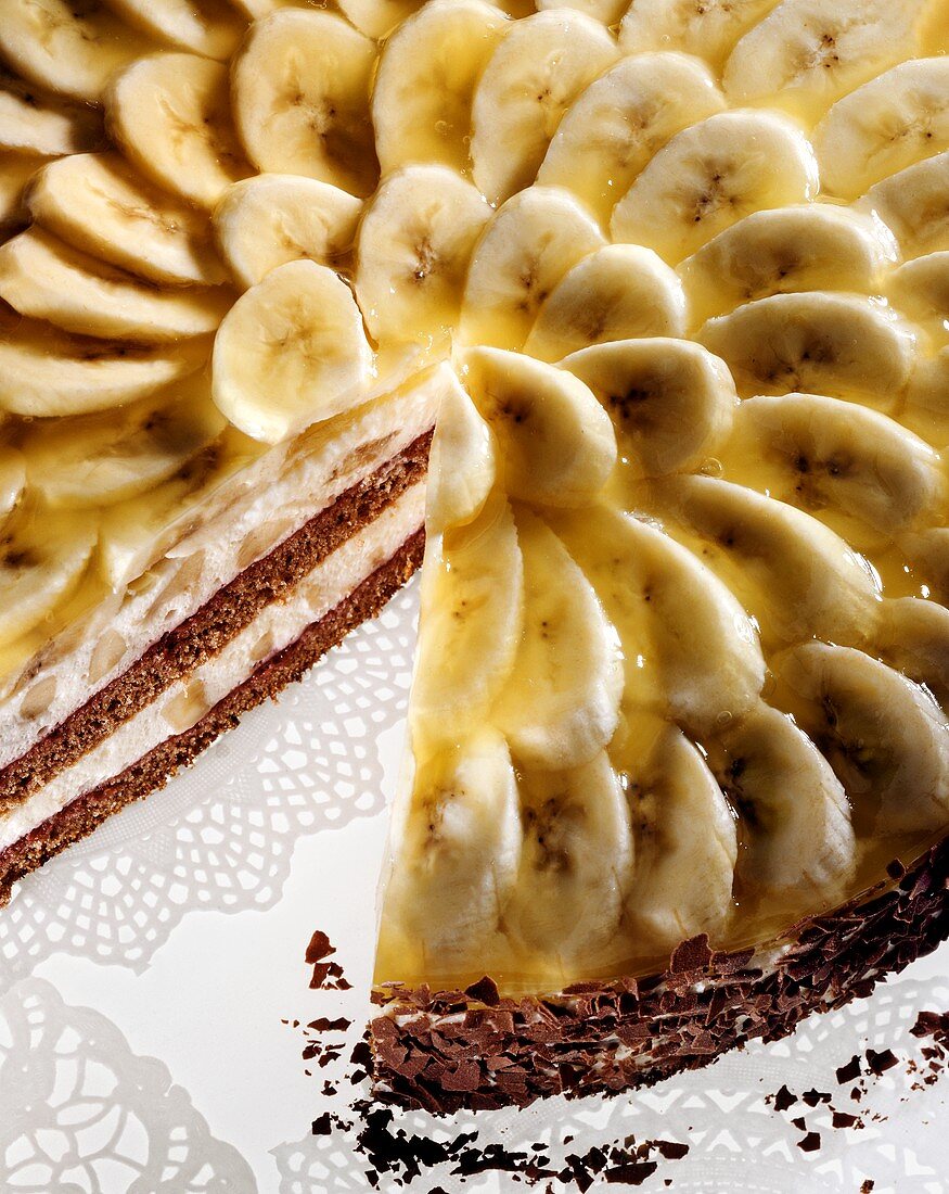 Banana gateau with banana slices & flaky chocolate edge