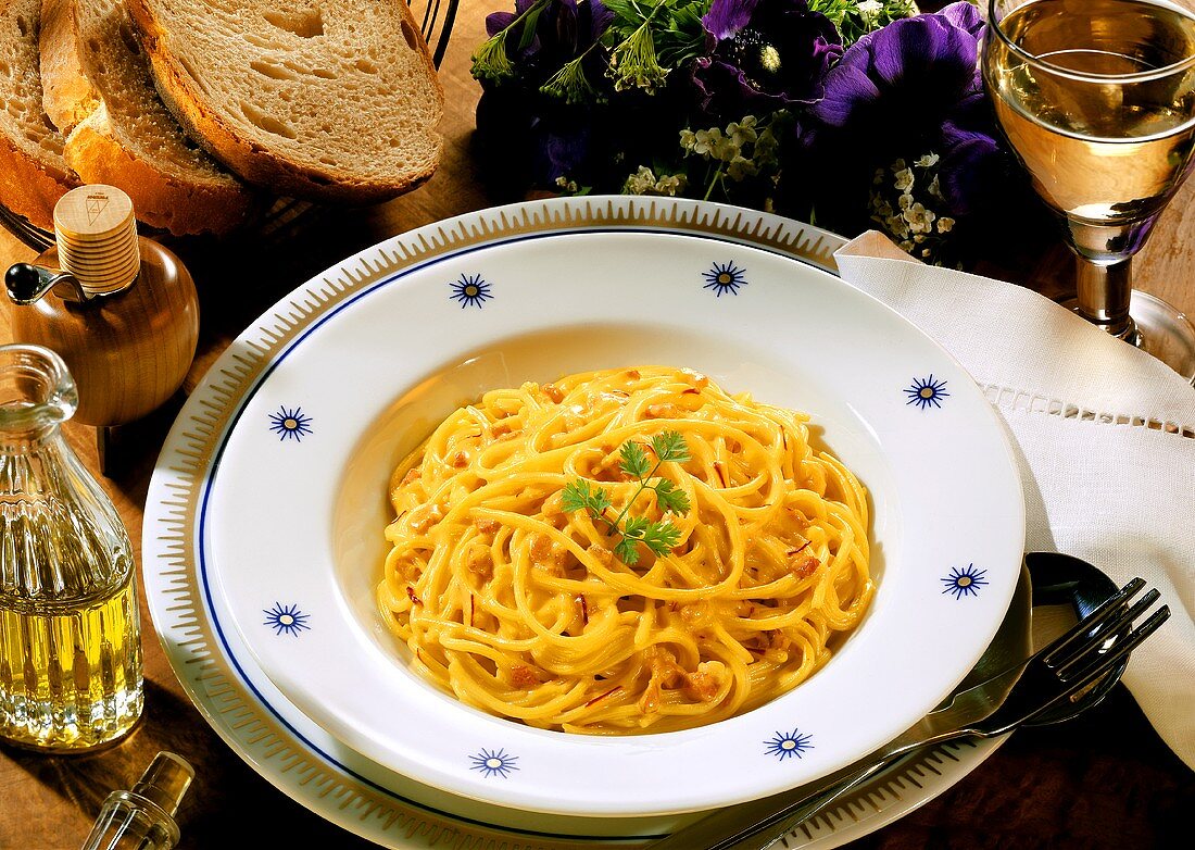Spaghetti with saffron sauce and parsley sprig