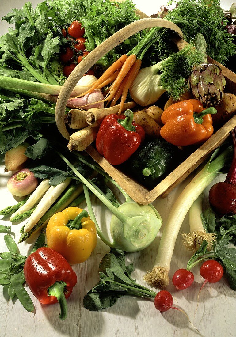 Various fresh vegetables, some in basket