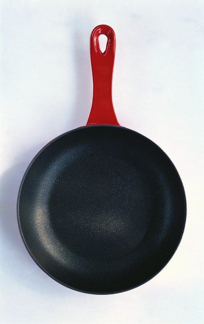 Teflon coated pan with red handle