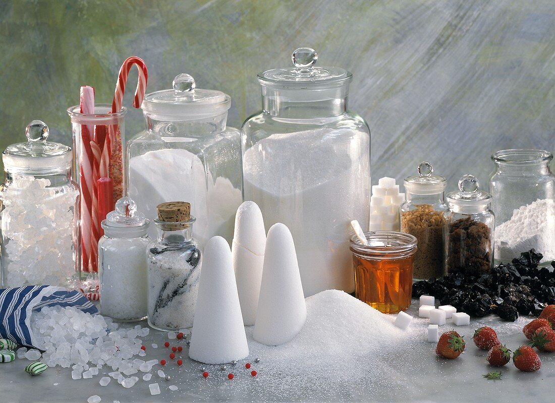 Still life with various types of sugar, candy canes, syrup