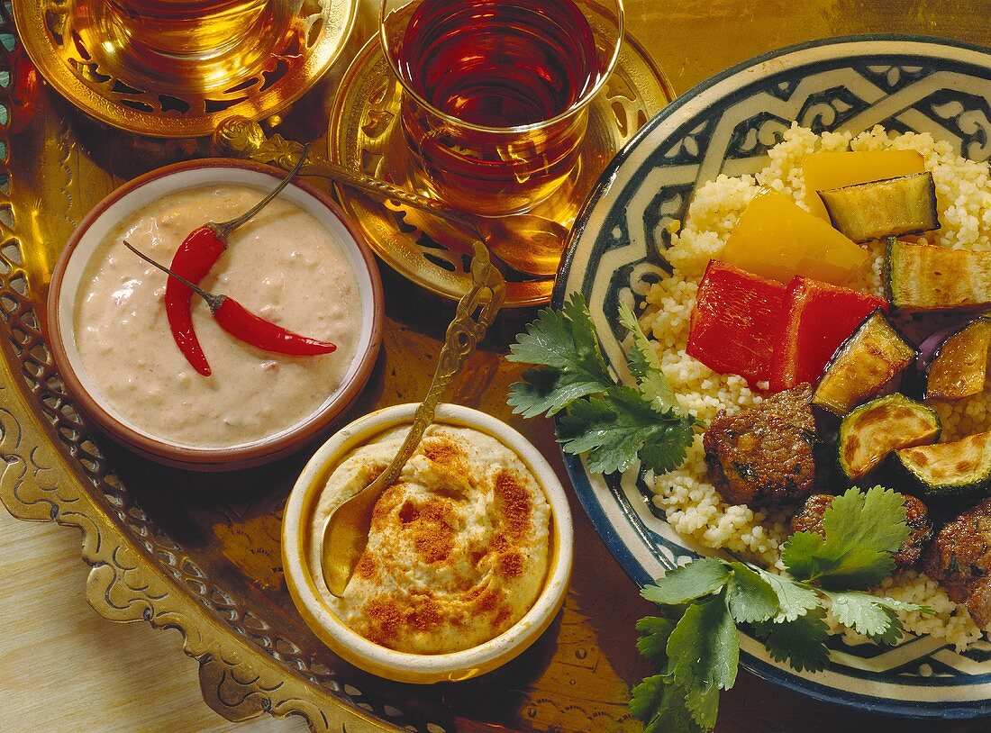 Moroccan fondue with lamb on couscous and dips