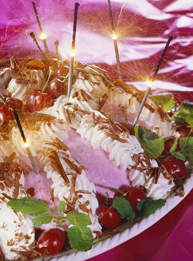 Black Forest cherry ice cream bombe with burning sparklers