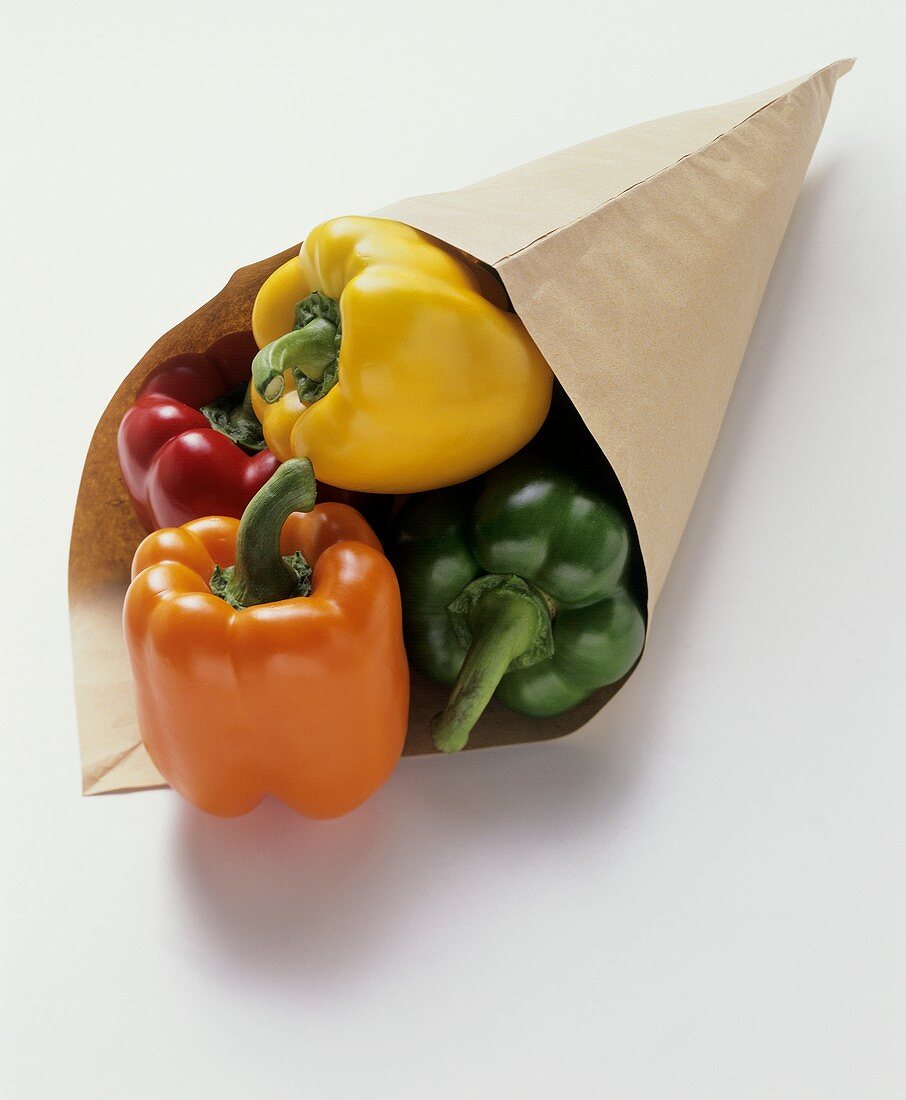Four peppers (red, yellow, green, orange) in paper bag