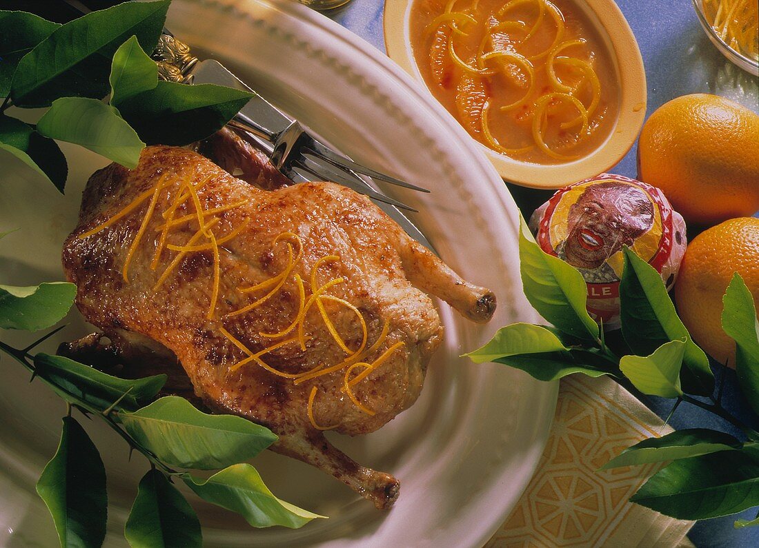Roast duck with orange zest & orange sauce in bowl