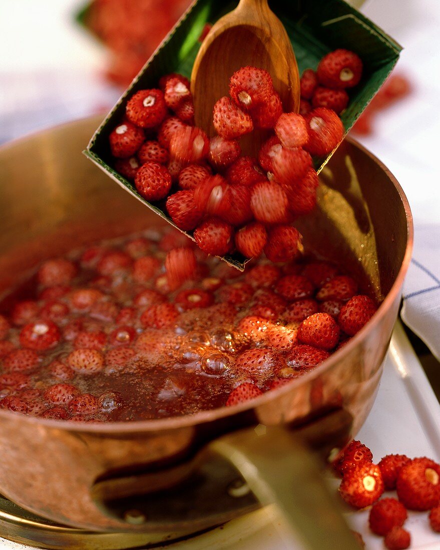 Strawberries Being Poured into Boiling Amaretto Sauce