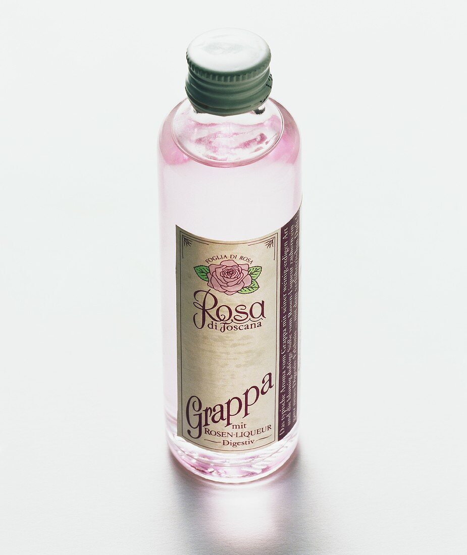A bottle of pink Grappa (label: Grappa Rosa di Toscana)
