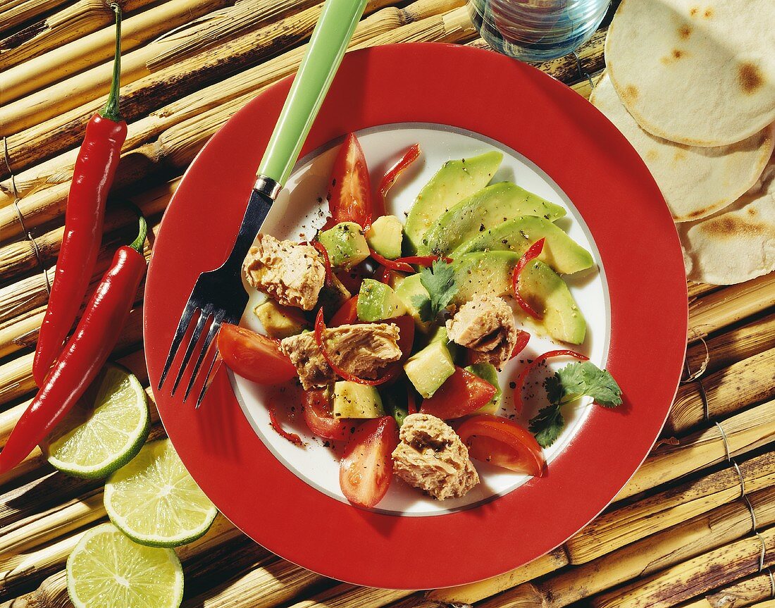 Tacos with tuna salad with avocados and tomatoes on plate