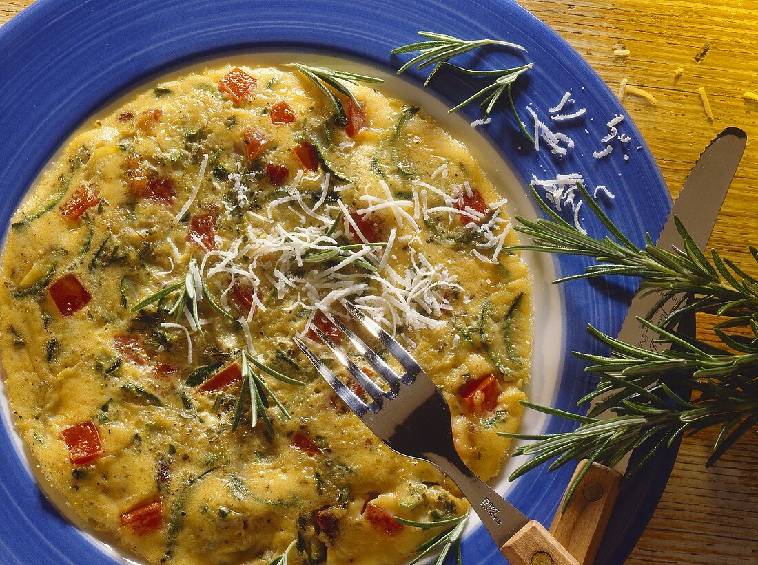Rosmarinomelett mit Zucchinifüllung & Parmesan auf Teller