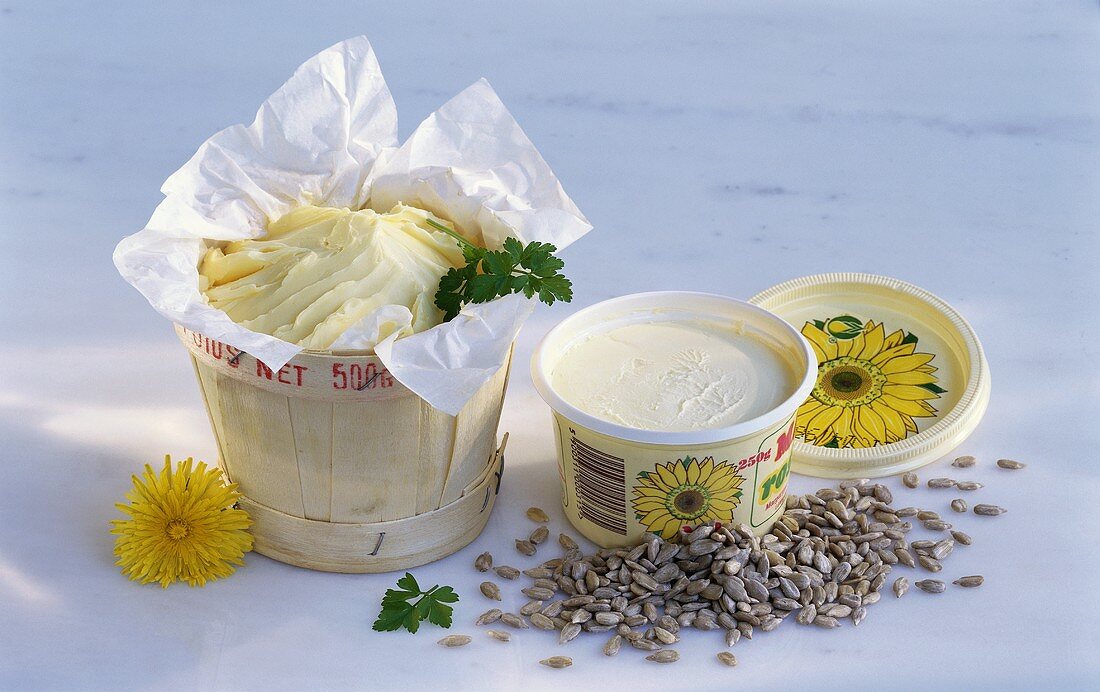 Butter in pot, sunflower margarine and sunflower seeds